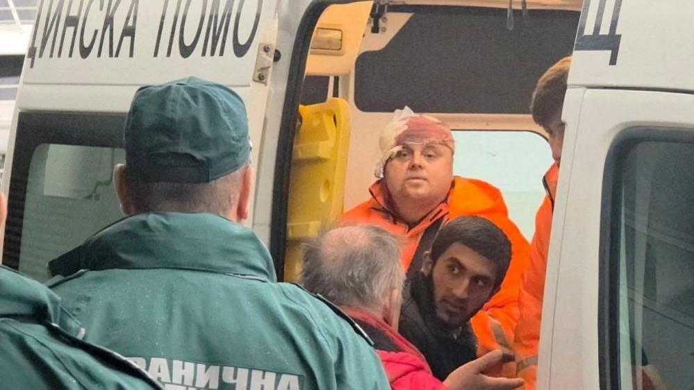 Rescued crew members from a merchant ship hit in a drone attack