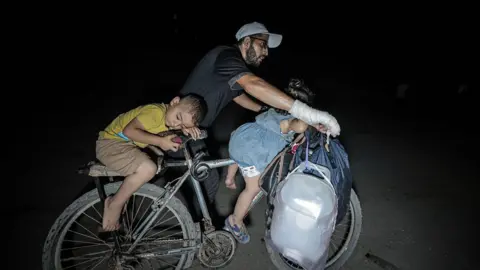 Fleeing Under Fire: Palestinians Escape Gaza City Amid Escalating Assault