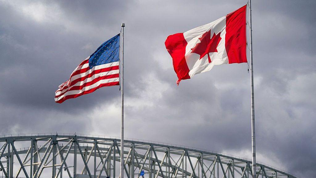 Canada and U.S. flags beside the Blue Water Bridge border crossing