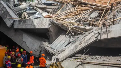 Tragedy Strikes: Indonesian School Collapse Claims Lives and Traps Students