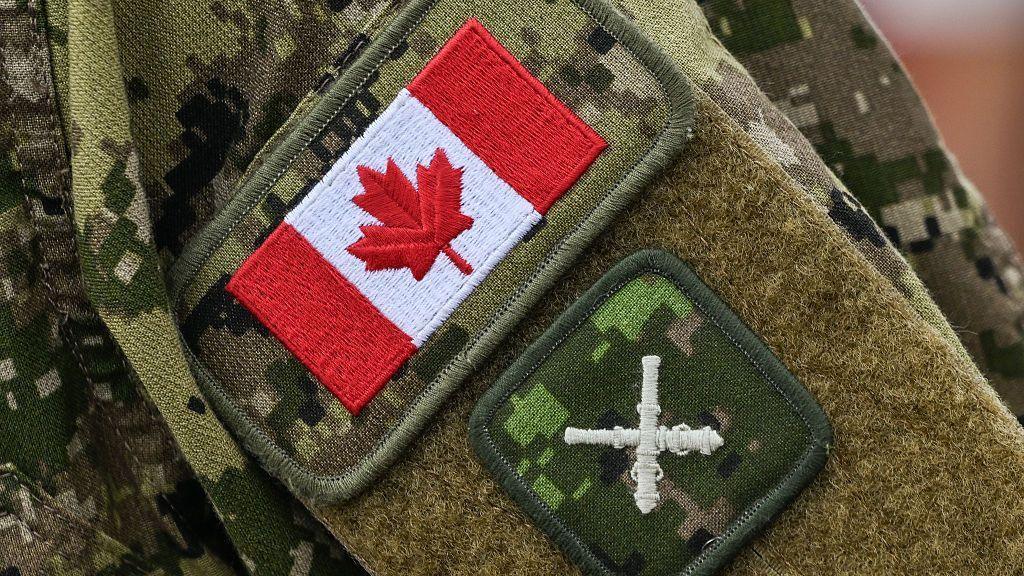 Canadian flag and Royal Regiment of Canadian Artillery gunner badges on a soldier’s sleeve