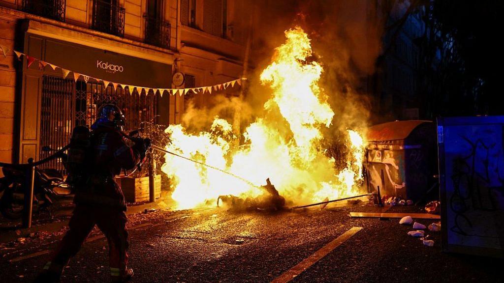 A burning makeshift street barricade in the southern French city of Marseille