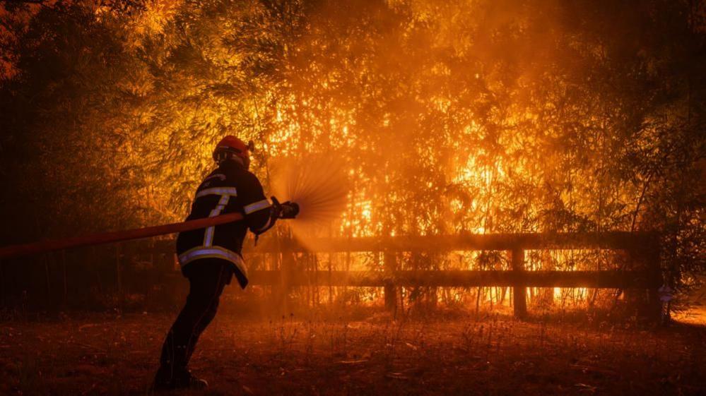 Firefighter battling wildfire near Ares, France