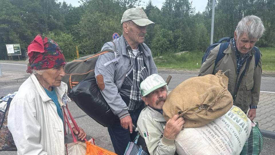 Four people carrying belongings leave Oleshky, Ukraine's southern city occupied by Russia