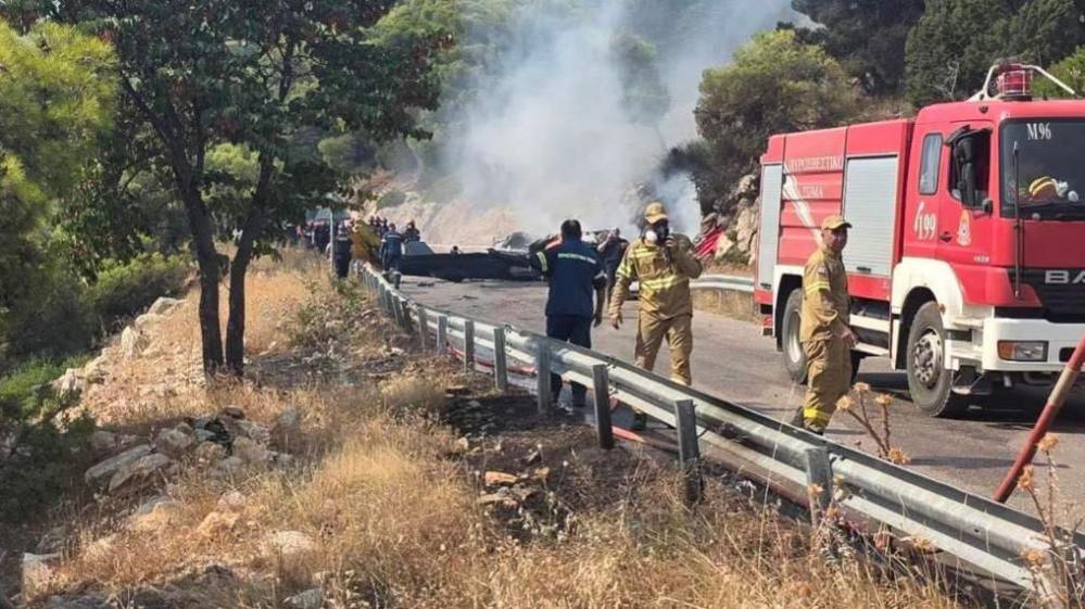 Firefighters and forensic experts at the crash site