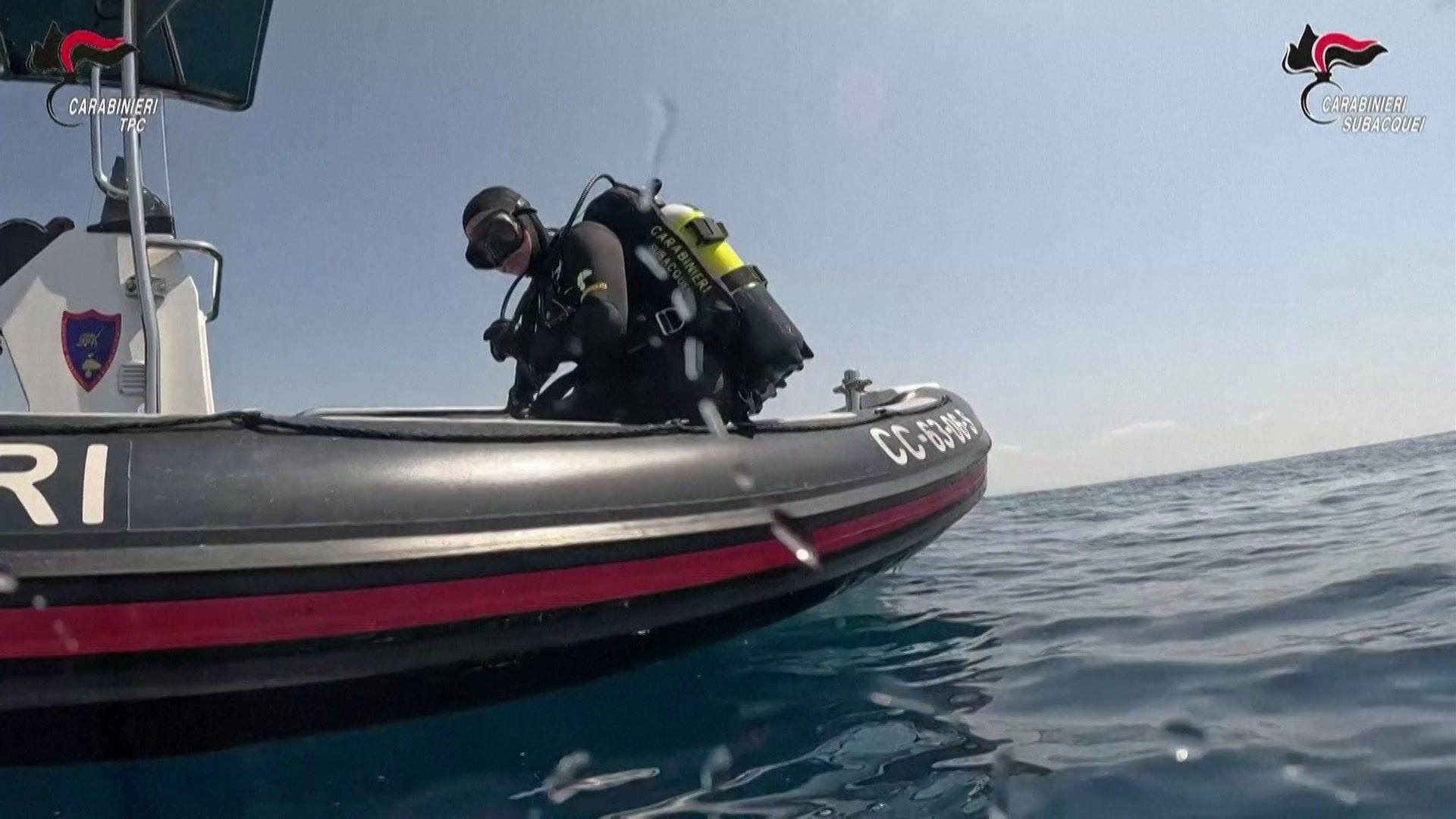 Divers amid a Roman shipwreck filled with amphorae off Sicily