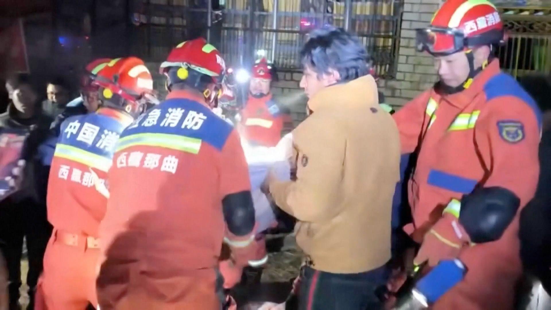Firefighters and residents helping victims of the earthquake trapped under rubble
